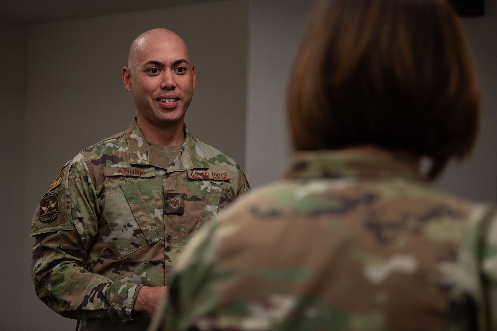 U.S. Air Force Staff Sgt. Raymond Aguon, left, 99th Civil Engineer Squadron Airmen dorm leader, briefs Chief Master Sgt. of the Air Force JoAnne S. Bass, on dorm life at Nellis Air Force Base, Nevada, May 2, 2023.