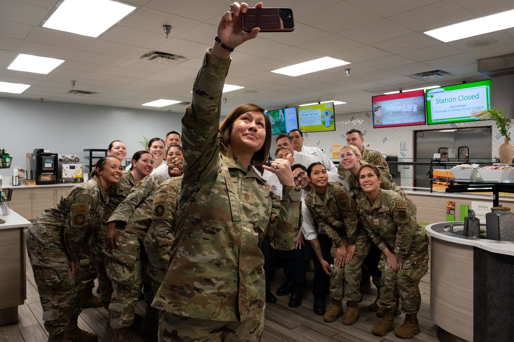 Chief Master Sgt. of the Air Force JoAnne S. Bass, takes a picture with 99th Force Support Squadron Airmen during a visit at Nellis Air Force Base, Nevada, May 2, 2023.