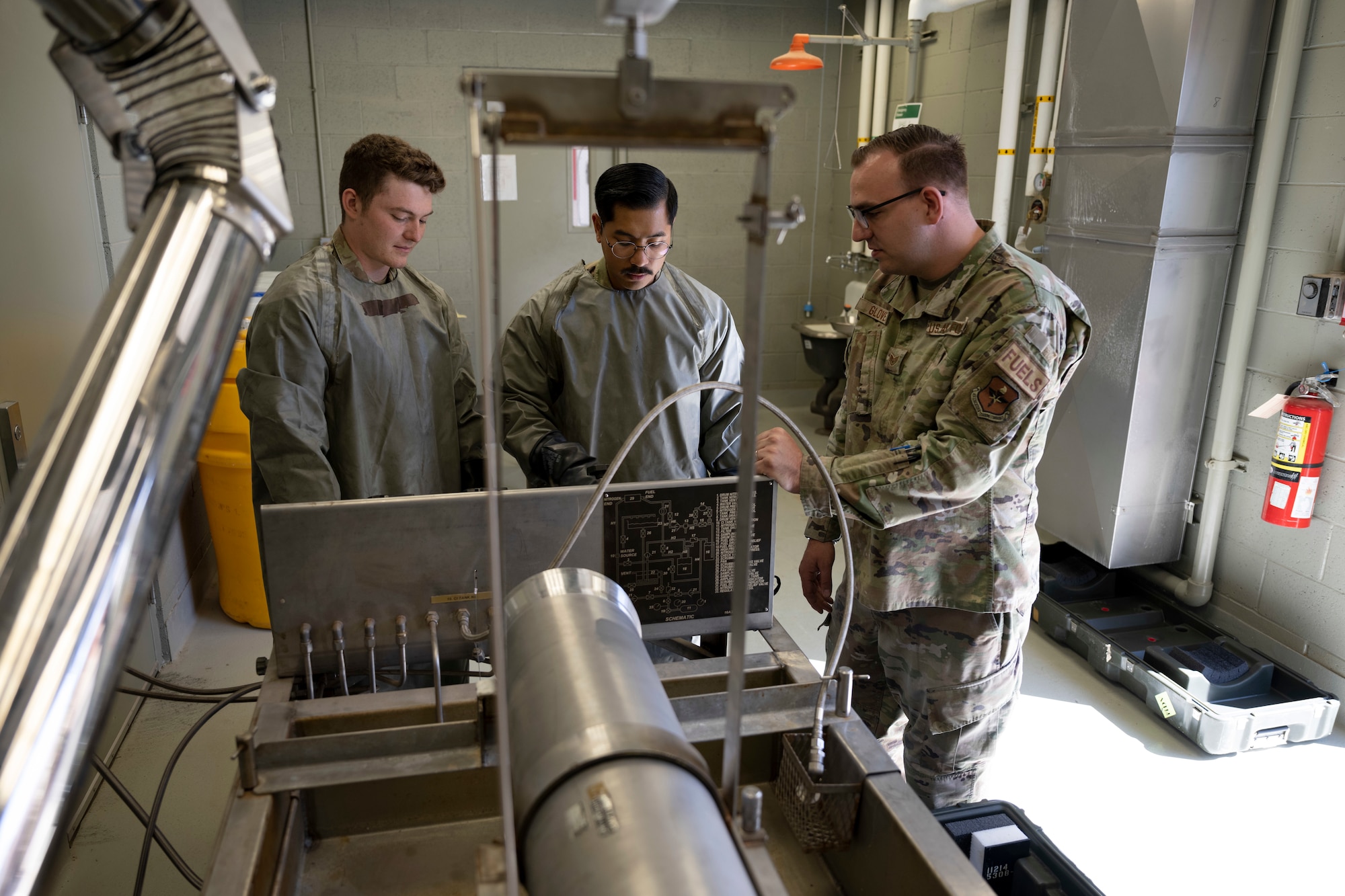 U.S. Air Force Airman 1st Class Cameron Kelley, 49th Component Maintenance Squadron aircraft fuel systems journeyman, left, U.S. Air Force Staff Sgt. Brandon Millare, middle, and U.S. Air Force Staff Sgt. Christopher Glover, 49th CMS aircraft fuel systems craftsman, discuss transportation and handling of hydrazine at Holloman Air Force Base, New Mexico, April 18, 2023.  Hydrazine plants require careful planning and engineering to ensure the safety of workers and the surrounding environment. (U.S. Air Force photo by Airman 1st Class Michelle Ferrari)