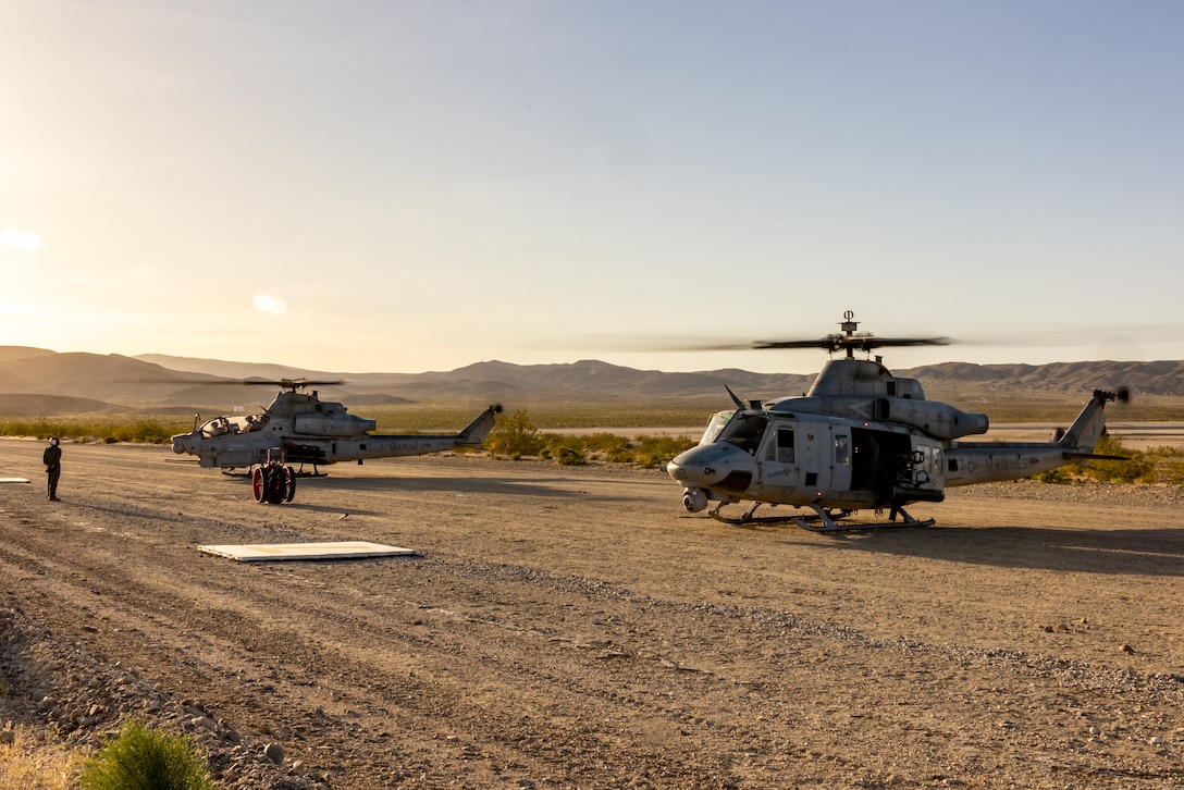 A U.S. Marine Corps UH-1Y Venom and an AH-1Z Viper, with Marine Light Attack Helicopter Squadron (HMLA) 367, Marine Aircraft Group 39, 3rd Marine Aircraft Wing, power up for a training mission during National Training Center Rotation 23-07