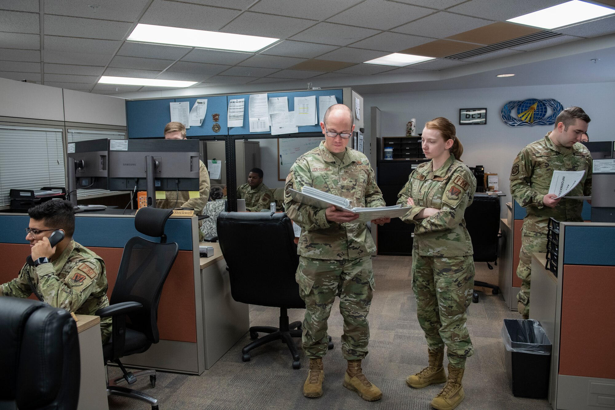 Service members working in an office.