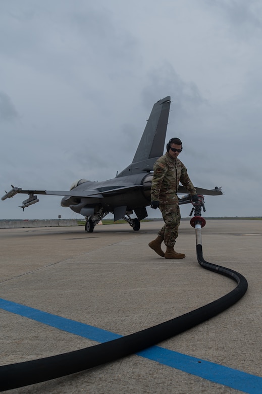 U.S. Air Force Senior Airman Gary Kittrell, 87th Logistics Readiness Squadron fuels service center controller performs hot-pit refueling on an F-16C+ Fighting Falcon.