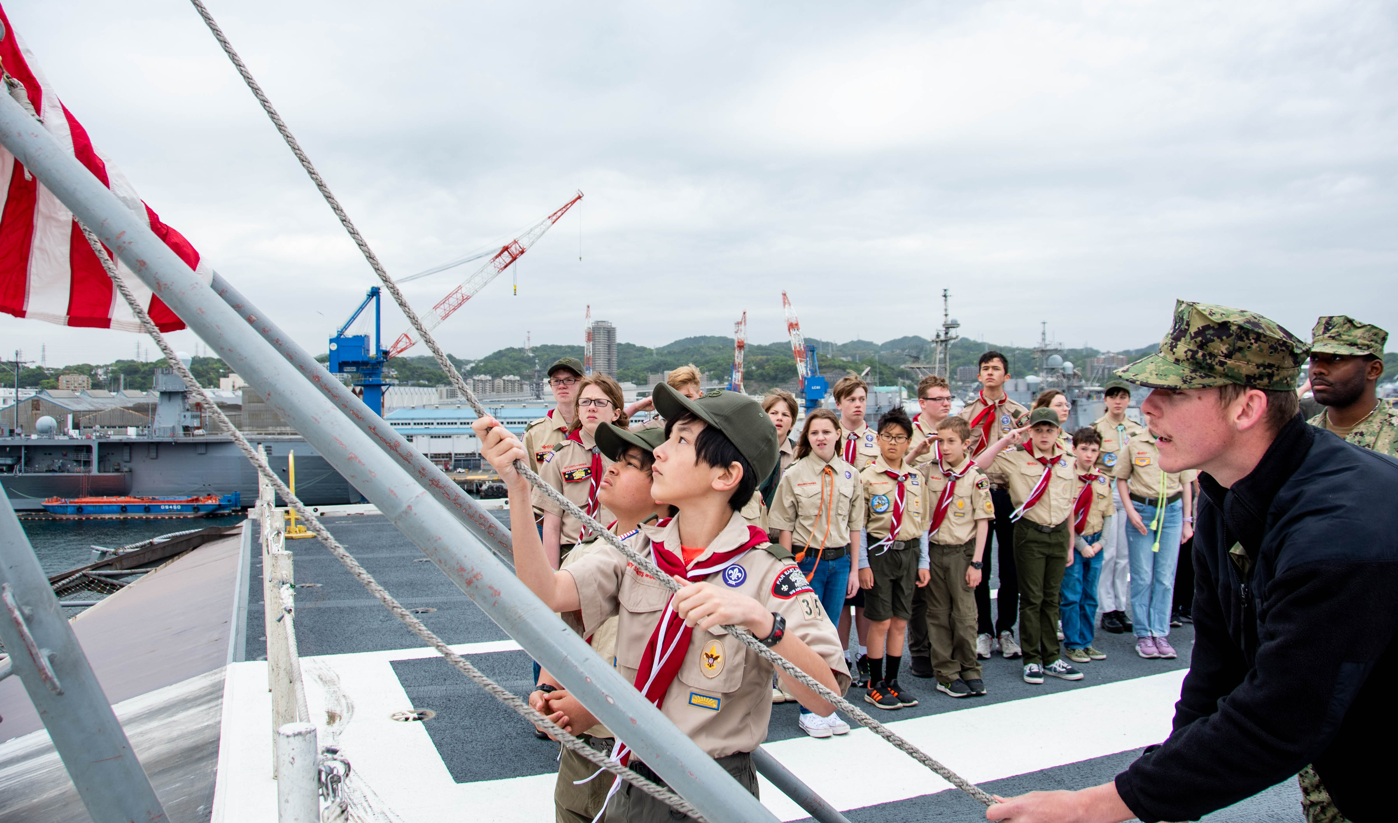 Sailors help Boy Scouts conduct morning colors aboard USS Ronald Reagan (CVN 76) at Commander, Fleet Activities Yokosuka.