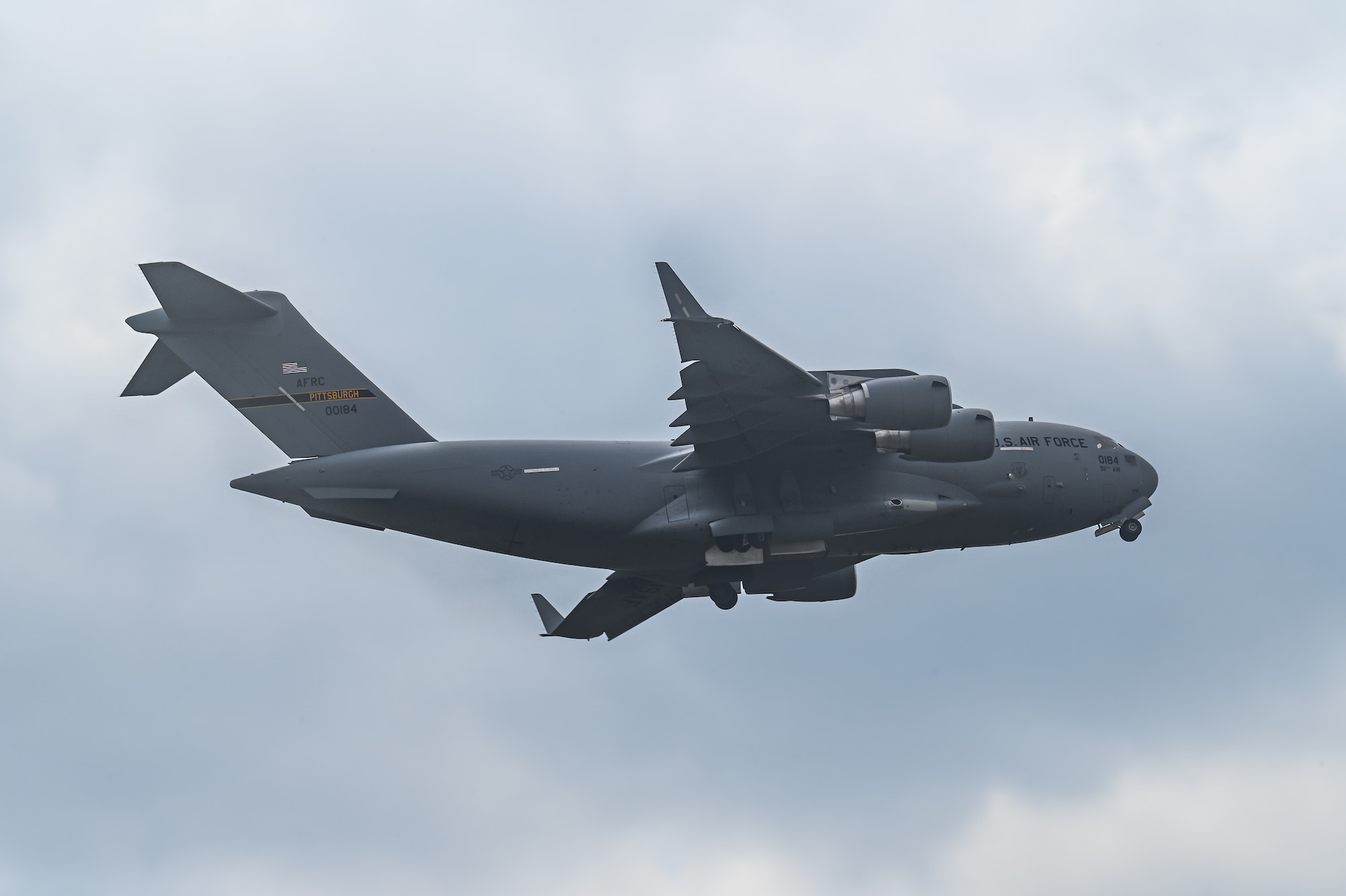 A C-17 Globemaster III aircraft assigned to the 911th Airlift Wing, Pittsburgh, flies over Youngstown Air Reserve Station, Ohio on April 25, 2023.