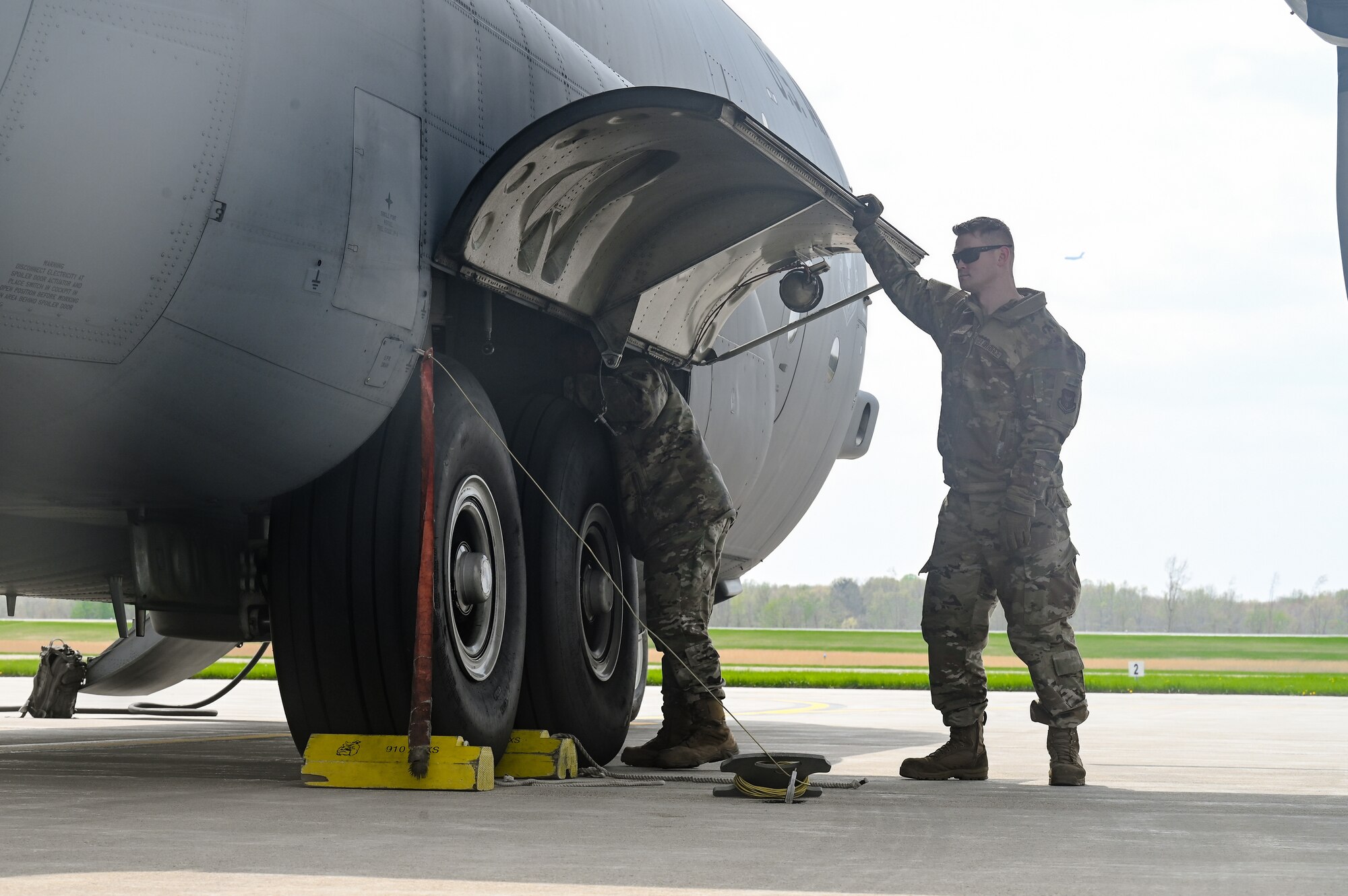 Tech. Sgts. Dale Burns and Taylor Webber, both aerospace maintenance specialists assigned to the 910th Maintenance Group, perform post-flight maintenance checks on a C-130H Hercules aircraft on April 25, 2023, at Youngstown Air Reserve Station, Ohio.