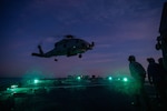 BALTIC SEA (March 8, 2022) — Sailors assigned to Arleigh Burke-class guided-missile destroyer USS Donald Cook (DDG 75) watch as an MH-60R Seahawk helicopter of the 