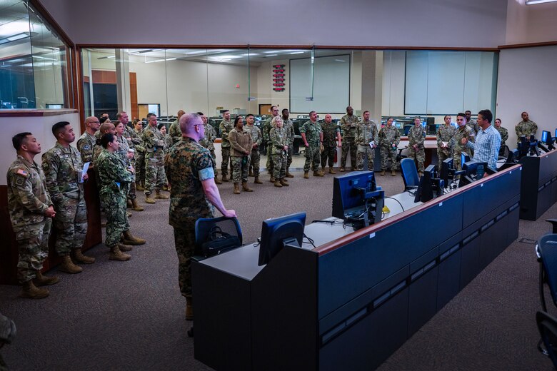 Participants of a Command Senior Enlisted Leader (CSEL) event receive a mission brief from members of the Western Range Operations Control Center (WROCC) at Vandenberg Space Force Base, Calif., May 2, 2023. The WROCC is the command and control center for all Vandenberg launches and provides air, land and sea clearance for all launches. The CSEL event spanned three days with over 45 senior enlisted members from space-affiliated units participating in tours of space facilities, leadership seminars and mission-focused briefings. (U.S. Space Force photo by Tech. Sgt. Luke Kitterman)