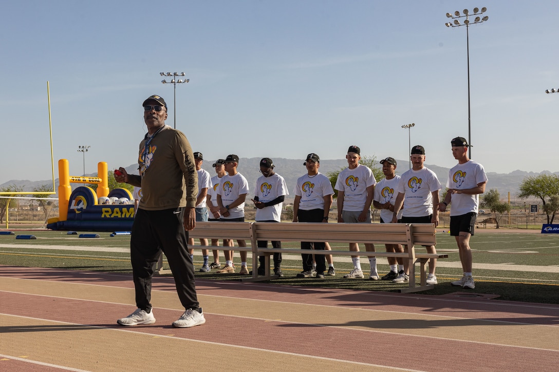 Los Angeles Rams speed and agility coach Mo Streety speaks to families during a Los Angeles Rams Performance Camp at Marine Corps Air Ground Combat Center (MCGACC), Twentynine Palms, California, April 25, 2023. USO brought the Los Angeles Rams Performance Football Camp to MCAGCC, allowing children of service members the opportunity to be coached on basic football concepts and transferrable life skills gained through playing football. (U.S. Marine Corps Photos by Lance Cpl. Pedro Arroyo Jr.)