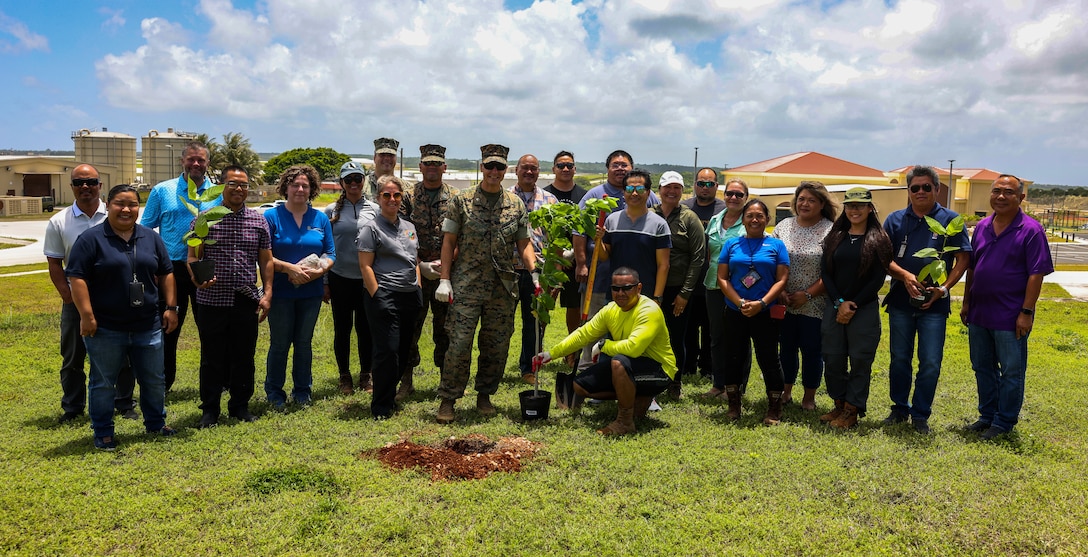Service members from Marine Corps Base Camp Blaz and the natural resource specialist team with Naval Facilities Engineering Systems Command Marianas pose for a photo during an outplanting event held at the Marine Wing Support Squadron (MWSS) facilities on Andersen Air Force Base, Guam, April 21, 2023. The saplings that were planted around the MWSS facilities were previously housed at one of the four plant nurseries on Camp Blaz. Totaling 18,000 square-feet, the plant nurseries are used to promote the growth of healthy plant material and propagated seeds until they are ready to be transplanted at various locations on Guam. (U.S. Marine Corps photo by Lance Cpl. Garrett Gillespie)