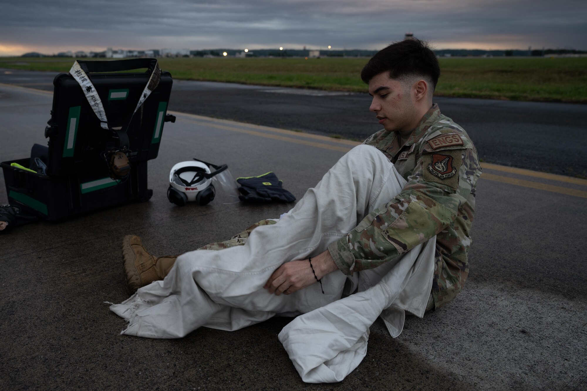 A young man puts on white protective equipment.