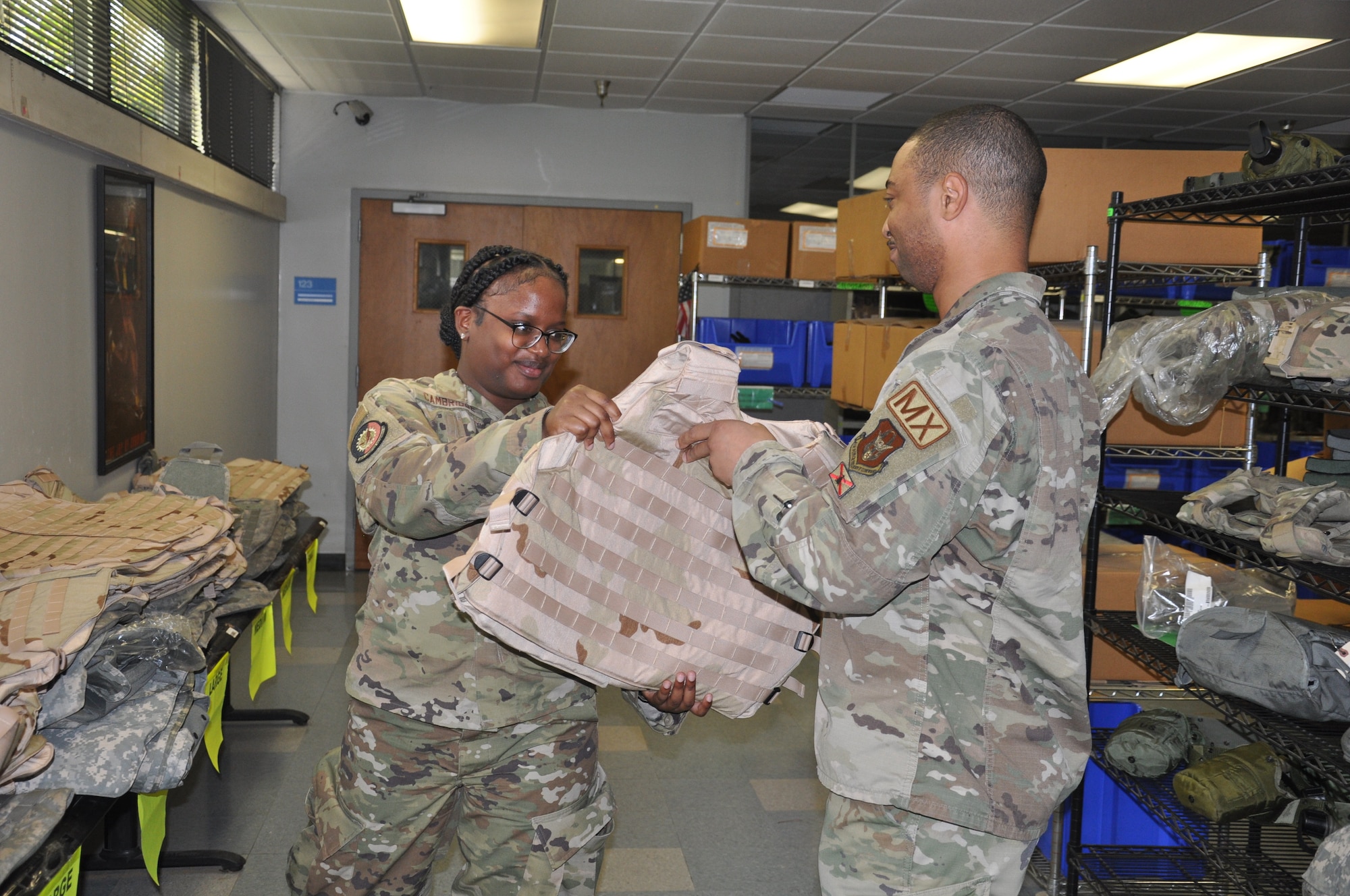 a person hands another person a vest