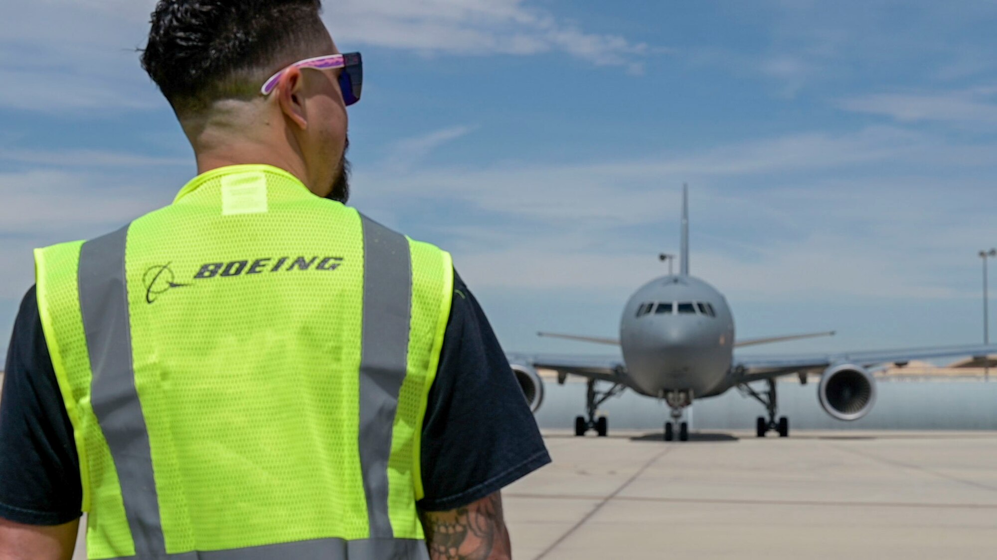 A Boeing maintainer gets ready to guide a KC-46 Pegasus out of of the flight-line to conduct an air refueling test mission at Edwards Air Force Base, Calif. It is a joint effort between Boeing, Air Mobility Command, Air Force Test Center, 418th Flight Test Squadron and Air Force Life Cycle Management Center to successfully complete the mission.