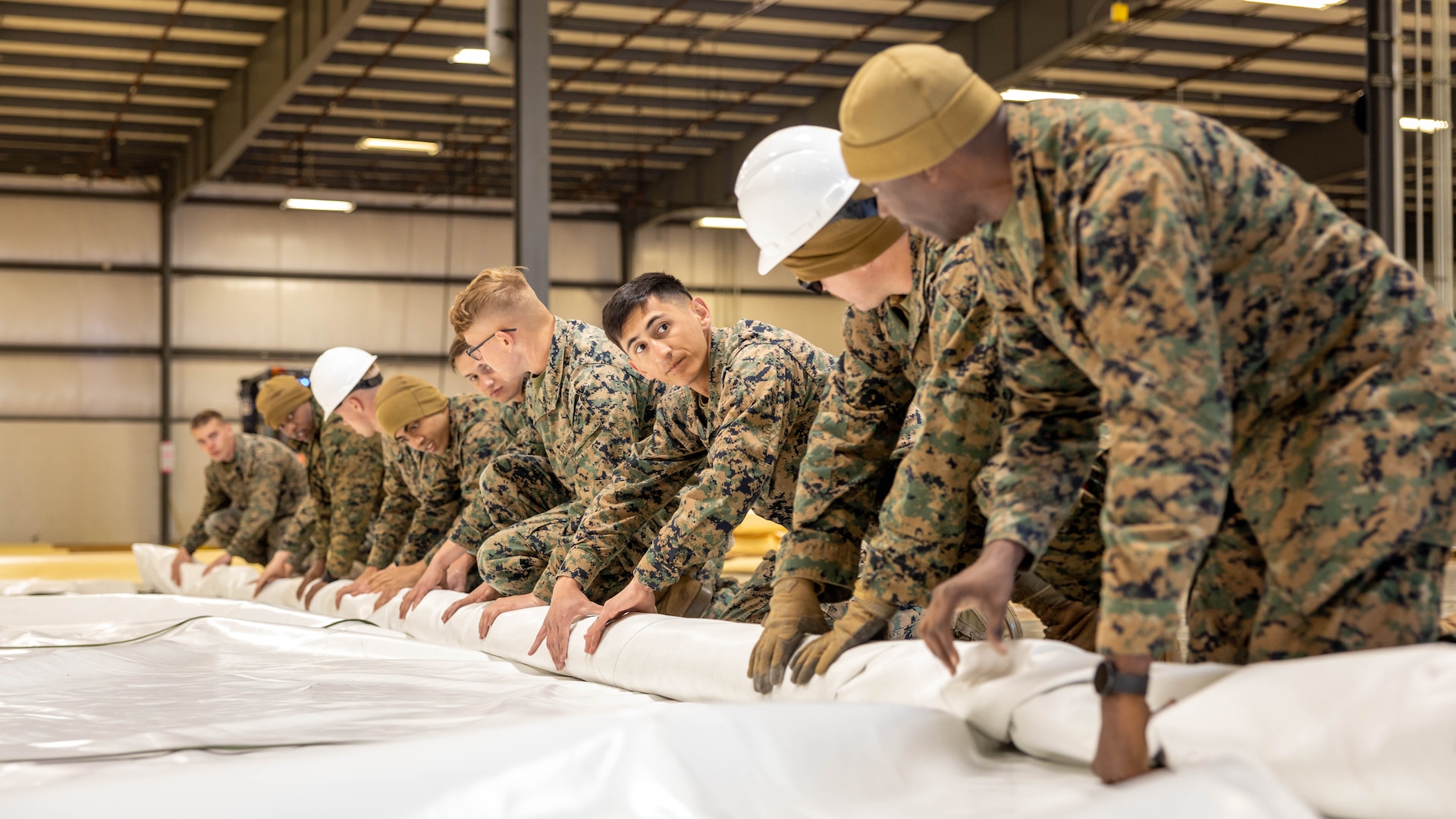 U.S. Marines with 1st Marine Expeditionary Force and 3rd Marine Expeditionary Force, help construct the Modular Fuel Tank System in South Bend, Indiana, April 18, 2023. The purpose of prototype tank capability training is to gain operational advantage in the emplacement of fuel storage capacity throughout the joint force and attendees of this training will become subject matter experts; able to train other Marines, members of the joint force, and personnel across our network of allies and partners. The new fuel system only requires a small team to construct and can move with the unit to austere environments. (U.S. Marine Corps photo by Cpl. Haley Fourmet Gustavsen)