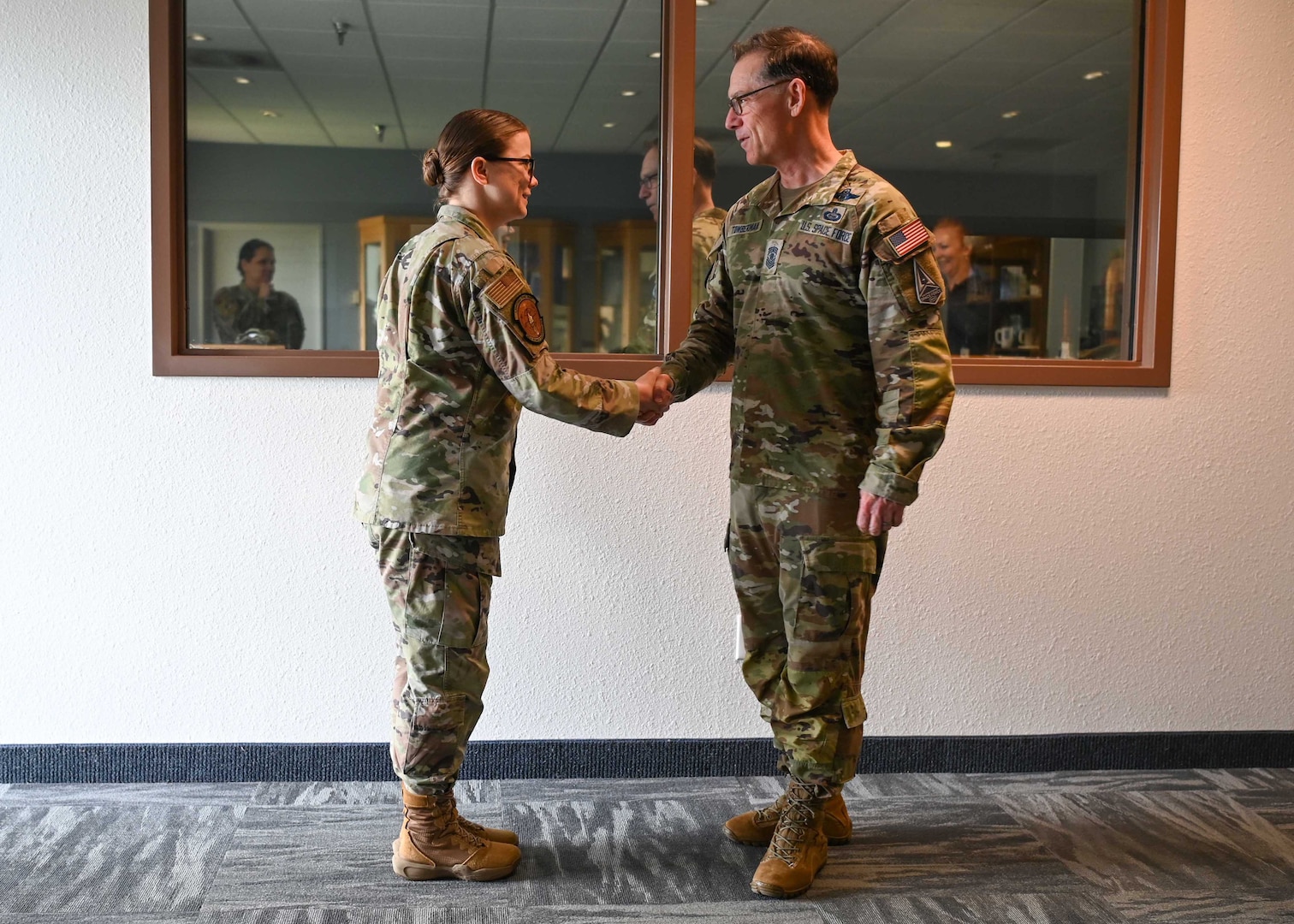 Chief Master Sgt. of the Space Force Roger A. Towberman coins U.S. Air Force Staff Sgt. Emerald Hicks, 30th Force Support Squadron professional military education instructor before speaking to the Airman Leadership class 22-D at Vandenberg Space Force Base, Calif., May 2, 2023. Towberman is the first U.S Space Force Chief Master Sergeant to be appointed to the highest senior noncommissioned officer position. (U.S. Space Force photo by Senior Airman Tiarra Sibley)