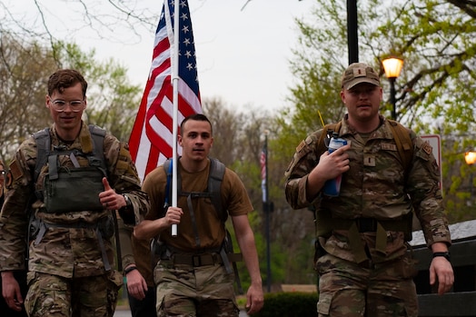  U.S. Air Force Technical Sgt. Kyle Townshend (left), a member of the Signals Analysis Squadron, National Air and Space Intelligence Center, gives a thumbs-up as he and approximately 30 others from NASIC make their way along the 30-mile Bataan Memorial Death March in Beavercreek, Ohio, April 14, 2023. Townshend, who organized the event, said he would have marched the full-marathon distance by himself, but was immensely grateful to do it instead with the 30 participants who showed up this year.