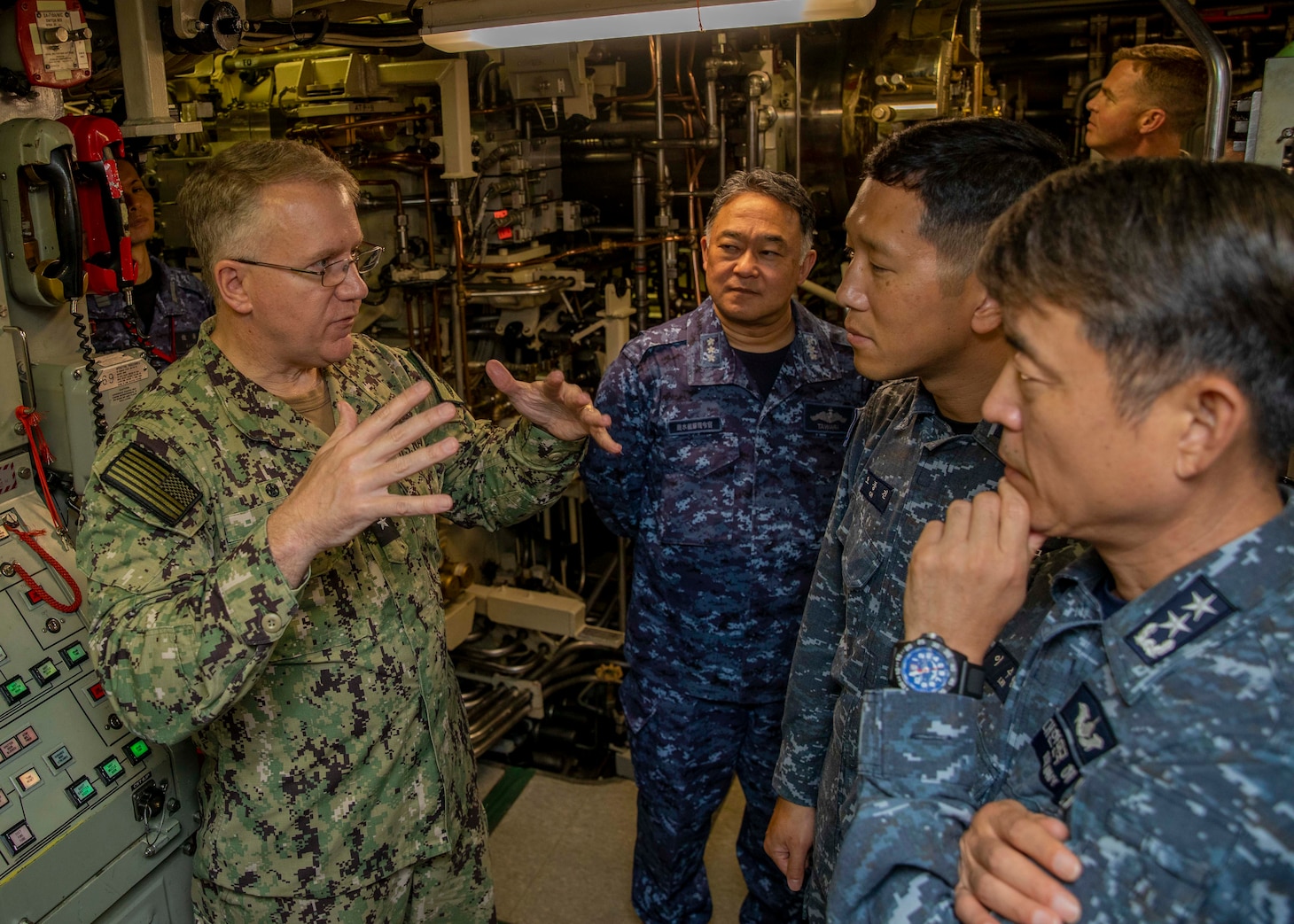 U.S. Navy Rear Adm. Rick Seif, commander, Submarine Group 7, left, speaks with Japan Maritime Self-Defense Force Vice Adm. Tateki Tawara, commander, Fleet Submarine Force, second from left; Republic of Korea (ROK) Navy Rear Adm. Su Youl Lee, commander, Submarine Force, far right; and ROK Navy Lt. Cmdr. Dongkeon Oh, executive officer of ROK Navy submarine ROKS SON WON IL (SS-072); aboard the Ohio-class ballistic-missile submarine USS Maine (SSBN 741) during an underway embark in vicinity of Guam, April 18. During their time at sea aboard the submarine, the senior leaders were provided tours and demonstrations of the unit’s capabilities, which operates globally under U.S. Strategic Command.