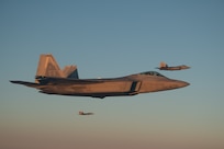 F-22 Raptors fly along a KC-135 during aerial refueling during Operation Hoodoo Sea May 1, 2023, over the Atlantic Ocean. The exercise, led by the Virginia Air National Guard, tested and validated minimum force elements using multi-capable Airmen executing functions across job specialties and platforms.