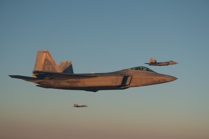 F-22 Raptors fly along a KC-135 during aerial refueling during Operation Hoodoo Sea May 1, 2023, over the Atlantic Ocean. The exercise, led by the Virginia Air National Guard, tested and validated minimum force elements using multi-capable Airmen executing functions across job specialties and platforms.