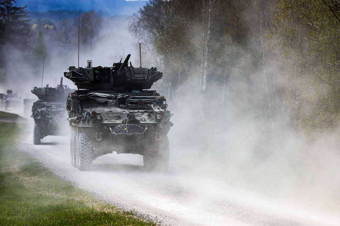 Tanks move down a road during a live fire exercise.