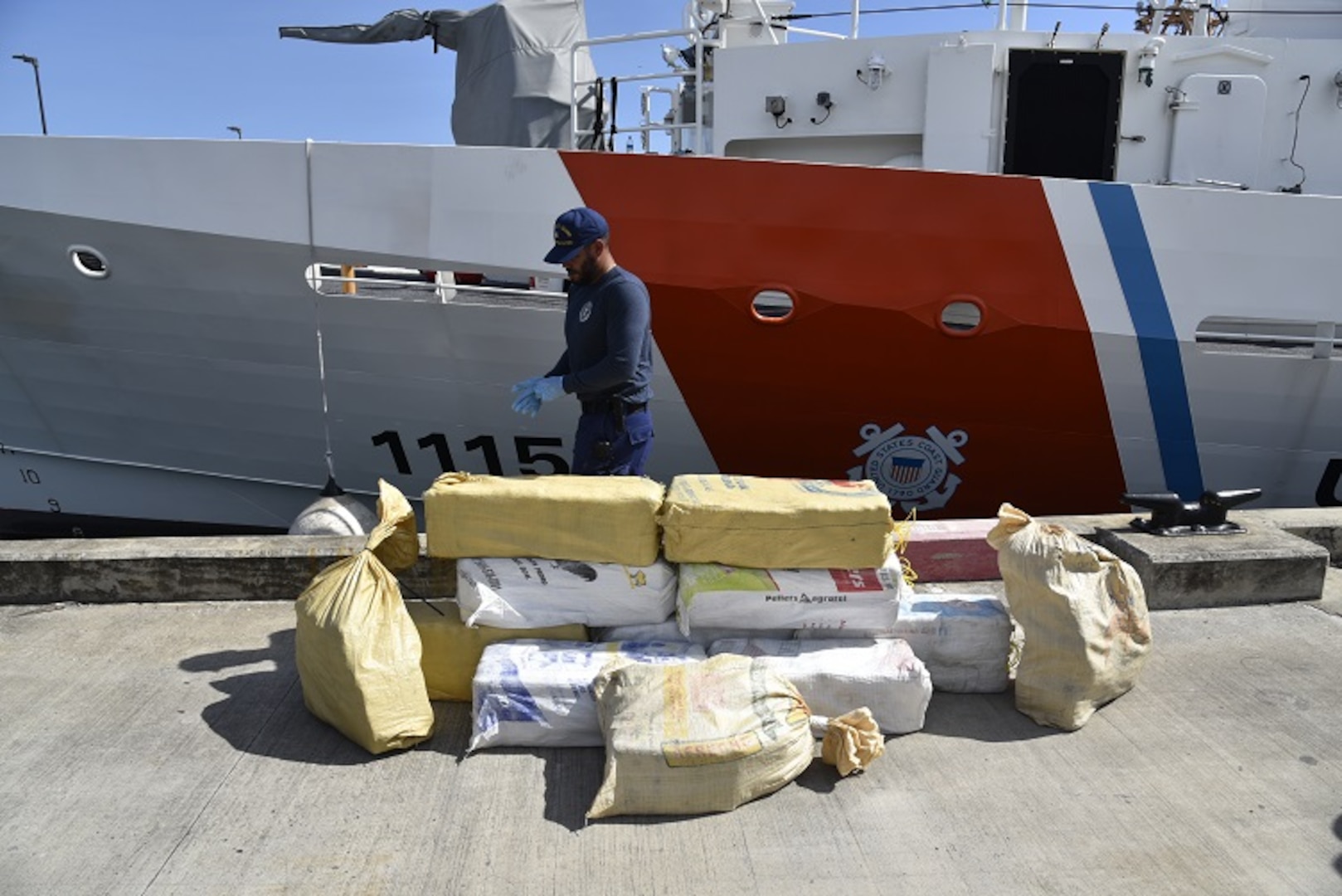 Coast Guard Cutter Joseph Napier crewmember helps offload 901 pounds of cocaine in San Juan, Puerto Rico, May 3, 2023.  The cutter crew also transferred three suspected smugglers apprehended in this case were to federal agents, following the interdiction of a drug smuggling go-fast vessel north of Puerto Rico, April 29, 2023.  (U.S. Coast Guard photo)