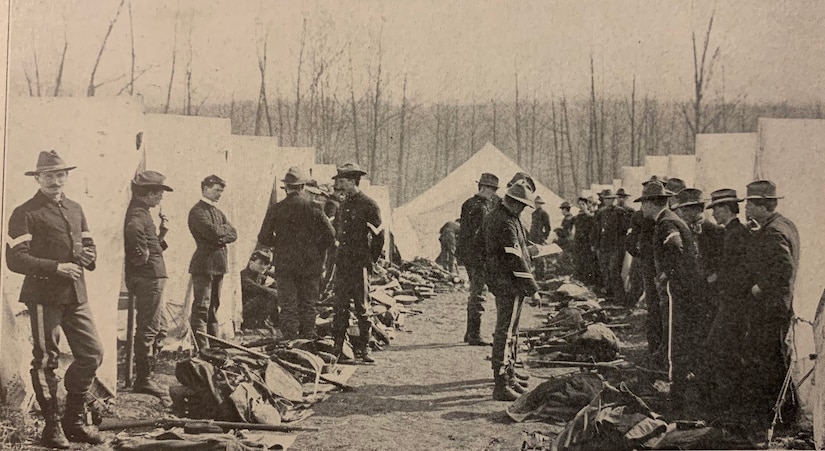 Soldiers from the National Guard of Pennsylvania congregate in a living area during the NGP's muster in Mount Gretna, Pennsylvania, in May 1898 for service in the Spanish-American War. (From "The Twenty-Eighth Division in the World War")