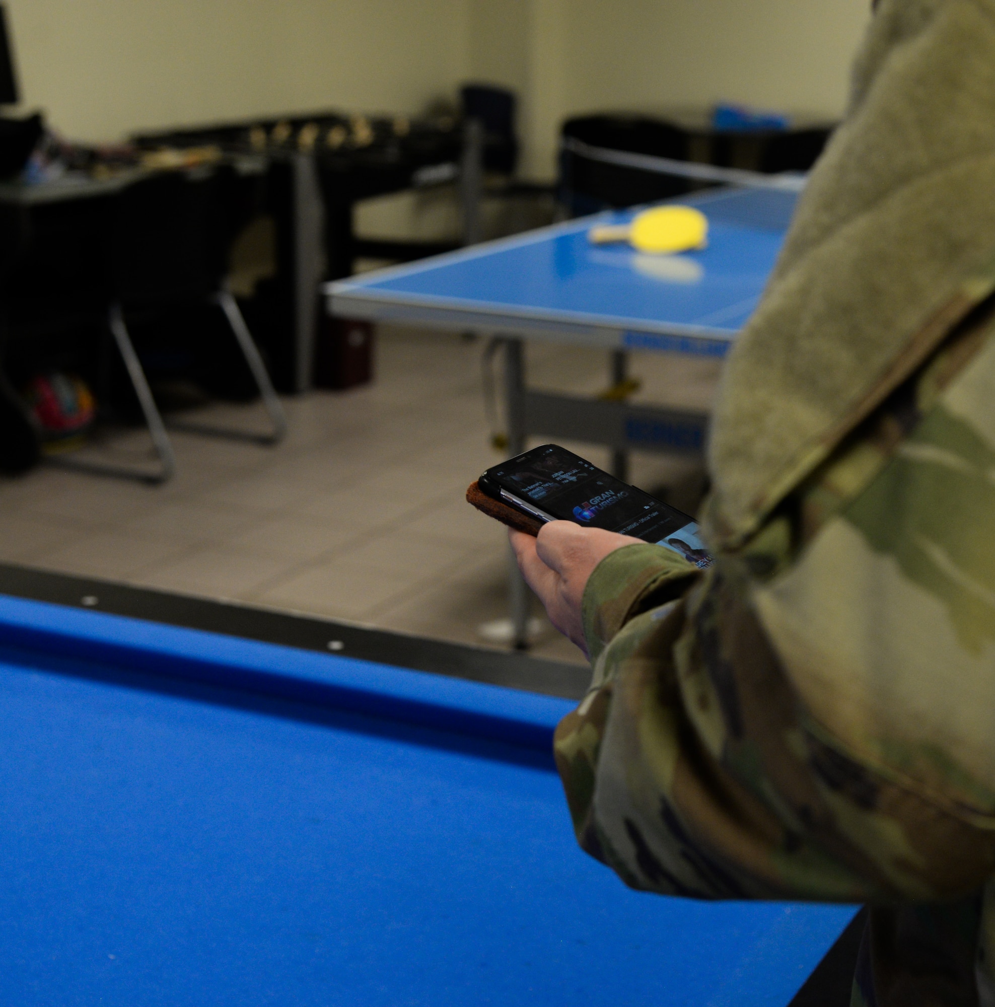 Airman using personal device to access a website in break area