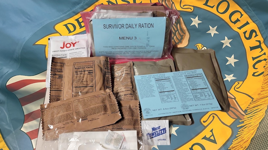 Components of a Survivor Daily Ration set with a Defense Logistics Agency flag backdrop