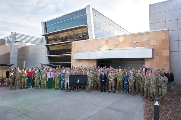Members of the 392d Combat Training Squadron stand with SPACE FLAG 23-2 participants for a group photo at Schriever Space Force Base, Colorado, April 17, 2023. SPACE FLAG 23-2 was the largest exercise iteration to date, involving 250 participants. It was also the most complex integration of cyber warfare, the largest integration of coalition partners ever at a SPACE FLAG exercise, and the first SPACE FLAG exercise to feature live-fire space electronic warfare. (U.S. Space Force photo by Judi Tomich)