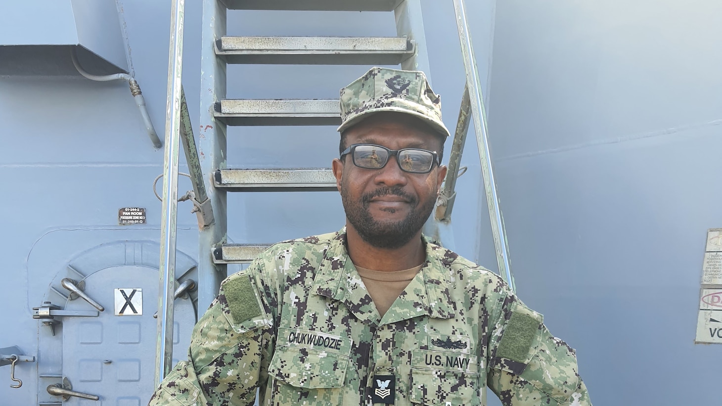 AQABA, Jordan (February 26, 2023) Hospital Corpsman 1st Class Ndudi Chukwudozie, of U.S. Navy Central Command’s Navy Reserve medical unit, poses for a photo aboard USS Truxtun (DDG 103) at the Royal Jordanian Naval Base in Aqaba, Jordan during International Maritime Exercise/Cutlass Express 2023. IMX/CE 2023 is the largest multinational training event in the Middle East, involving 7,000 personnel from more than 50 nations and international organizations committed to preserving the rules-based international order and strengthening regional maritime security cooperation. (U.S. Navy photo by Hospital Corpsman 1st Class Emilio Molina)
