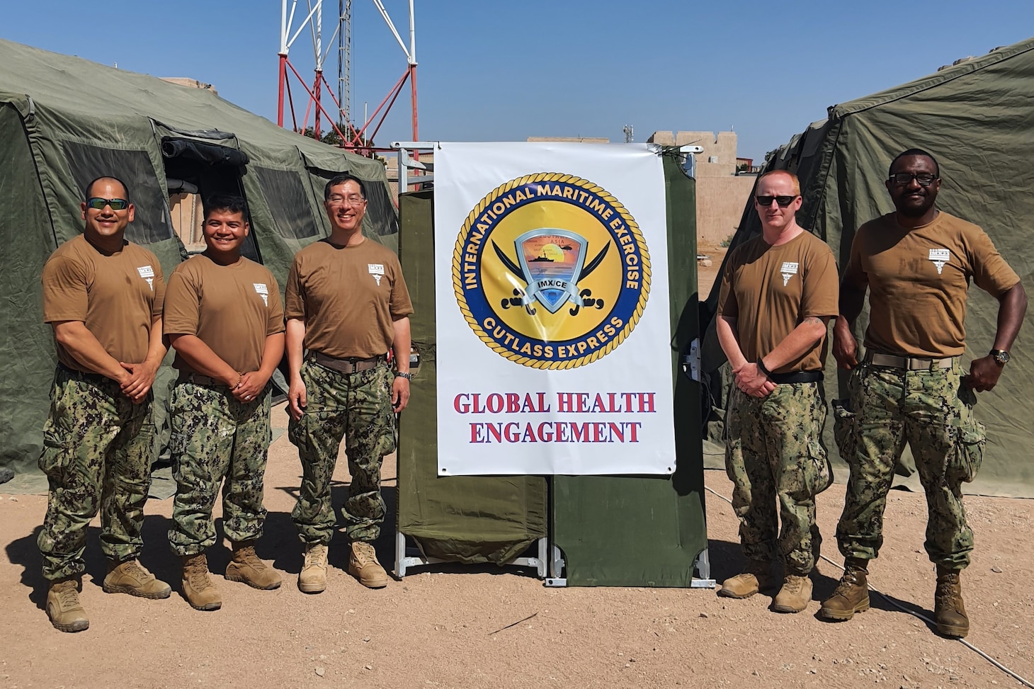 From left to right, Hospital Corpsman 1st Class Emilio Molina, of U.S. Navy Central Command’s Navy Reserve medical unit; Lt. Freddie Mawanay, health security cooperation officer and global health engagement liaison officer for NAVCENT; Capt. Jack Tsao, commanding officer of NAVCENT’s Navy Reserve medical unit; and Hospital Corpsman 1st Class Andrew Sinclair and Hospital Corpsman 1st Class Ndudi Chukwudozie, also of  NAVCENT’s Navy Reserve medical unit, pose for a photo during International Maritime Exercise/Cutlass Express 2023 at the Royal Jordanian Naval Base in Aqaba, Jordan. IMX/CE 2023 is the largest multinational training event in the Middle East, involving 7,000 personnel from more than 50 nations and international organizations committed to preserving the rules-based international order and strengthening regional maritime security cooperation. (U.S. Navy photo by Capt. Miguel Cubano)