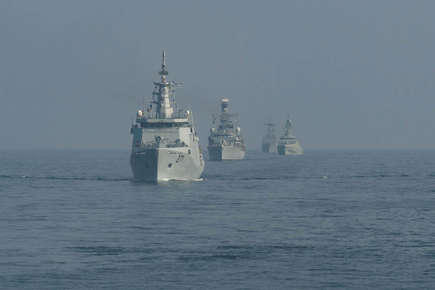 230315-N-NH267-1011 GULF OF OMAN (March 15, 2023) Ships sail in formation, March 15, 2023, in the Gulf of Oman during International Maritime Exercise 2023. IMX/CE 2023 is the largest multinational training event in the Middle East, involving 7,000 personnel from more than 50 nations and international organizations committed to preserving the rules-based international order and strengthening regional maritime security cooperation. (U.S. Navy photo by Mass Communication Specialist 2nd Class Elliot Schaudt)