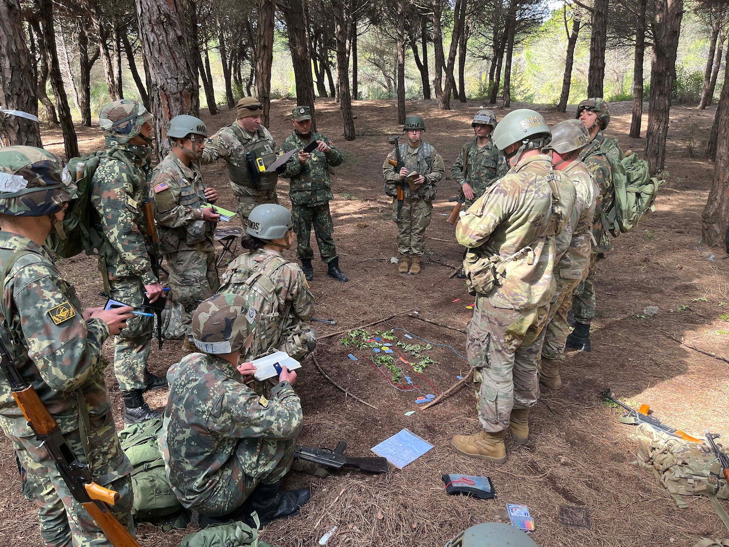 New York and New Jersey Army National Guard officer candidates and Albanian officer cadets listen during a mission briefing on April 12, 2023, near Rrogozhine-Kryevidh, Albania. The officer candidates participated in two weeks of training with Albanian officer cadets April 10-24 as part of a State Partnership Program exchange.
