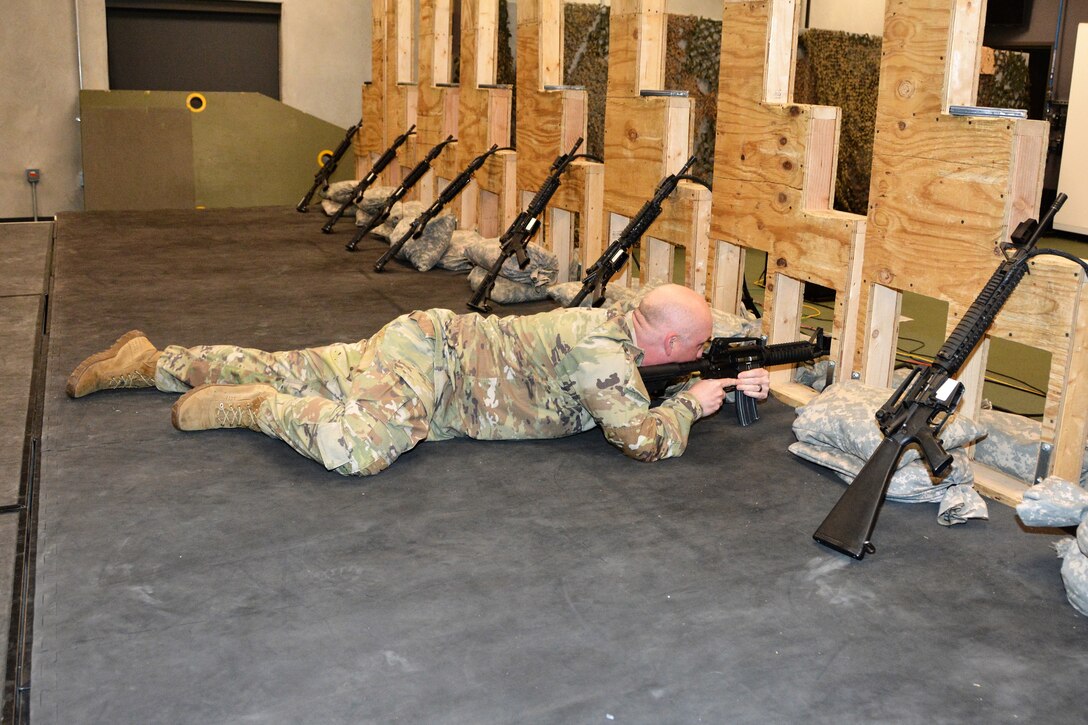 Sgt. 1st Class Damon Hassinger, Simulations noncommissioned officer in charge, demonstrates how to use an Engagement Skills Trainer at Fort Indiantown Gap's Training Support Center May 1, 2023. (Pennsylvania National Guard photo by Brad Rhen)