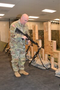 Sgt. 1st Class Damon Hassinger, Simulations noncommissioned officer in charge, discusses an Engagement Skills Trainer at Fort Indiantown Gap's Training Support Center May 1, 2023. (Pennsylvania National Guard photo by Brad Rhen)