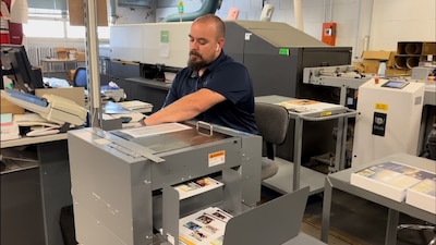 Man operates printer