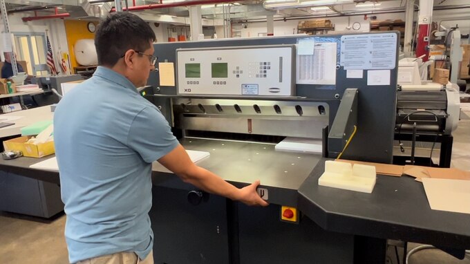 Man uses paper cutter