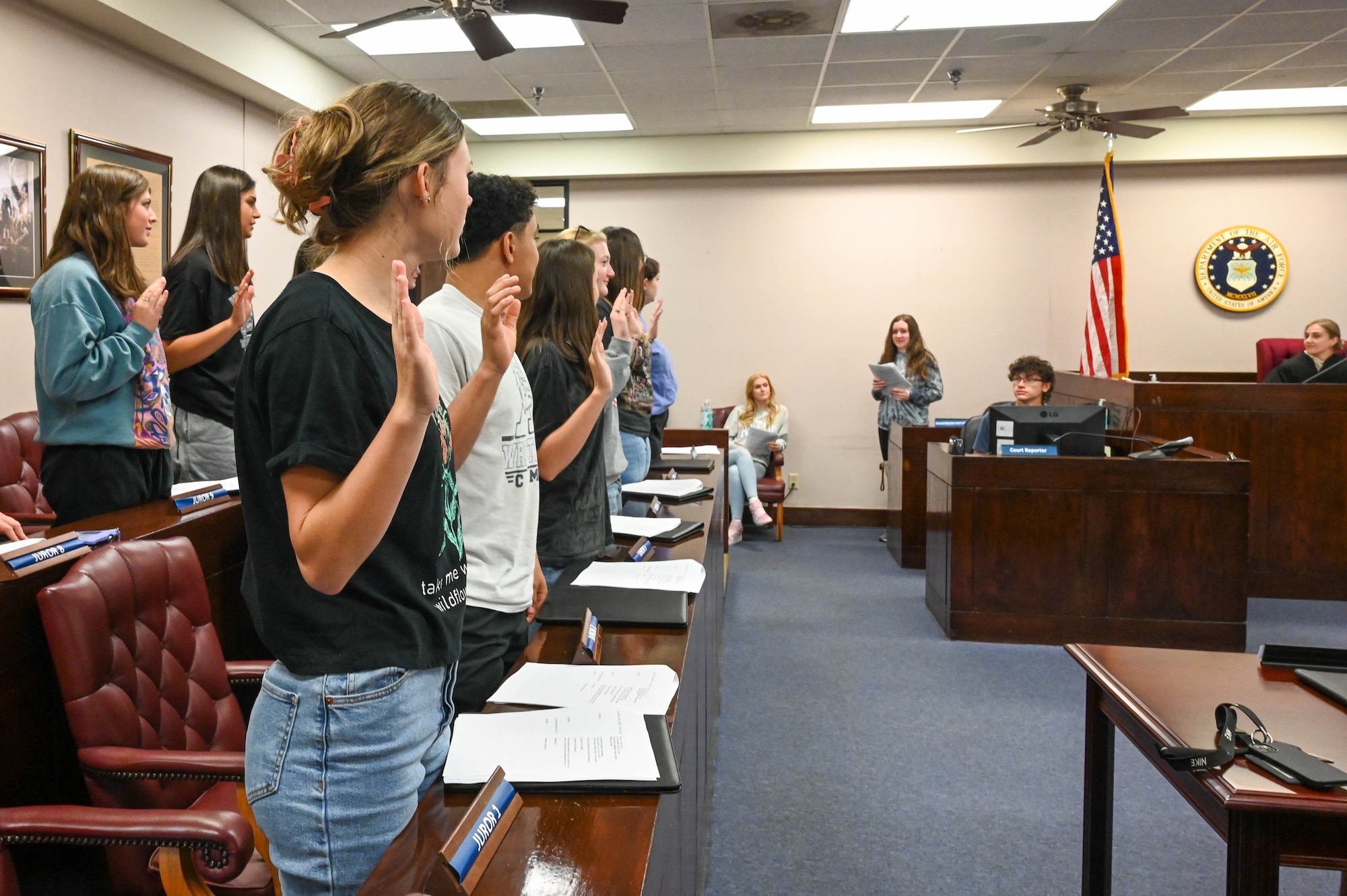 Students from Altus High School portraying jury members are sworn in during a mock trial at Altus Air Force Base, Oklahoma, May 1, 2023. During the trial, the jury had the opportunity to come up with their own decision based on evidence presented. (U.S. Air Force photo by Senior Airman Trenton Jancze)