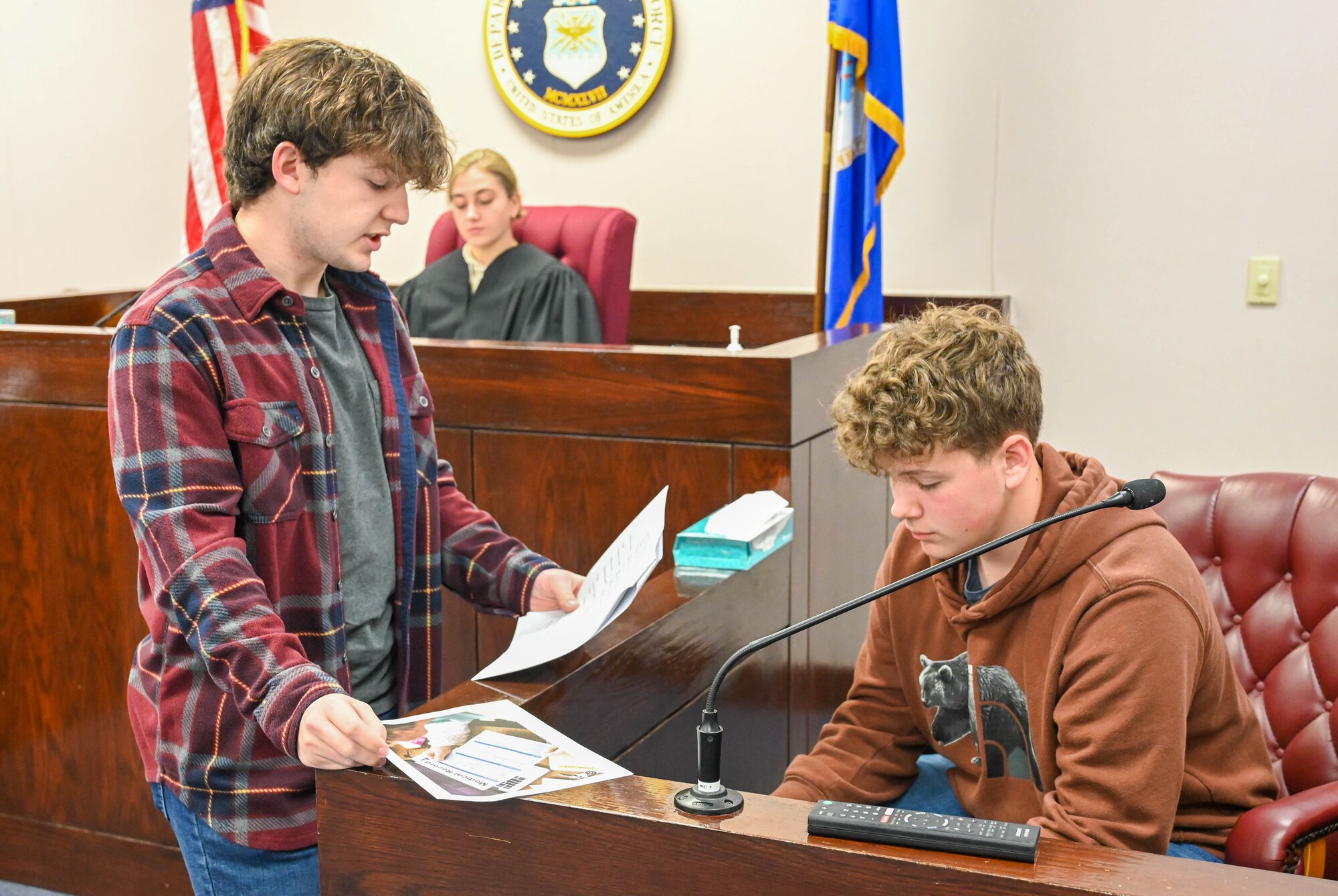 An Altus High School (AHS) student, questions another student, during a cross-examination period at a mock trial on Altus Air Force Base, Oklahoma, May 1, 2023. During the trial, students acted as the judge, plaintiff, defendant, jury and other key characters. (U.S. Air Force photo by Senior Airman Trenton Jancze)
