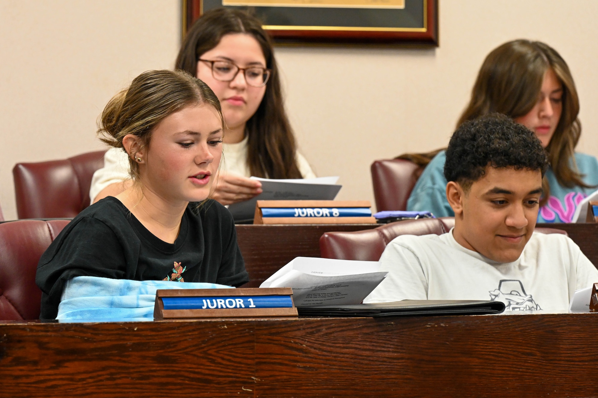 An Altus High School student reads from a script during a mock trial at Altus Air Force Base, Oklahoma, May 1, 2023. The students participated in a scripted trial and presented prepared evidence. (U.S. Air Force photo by Senior Airman Trenton Jancze)
