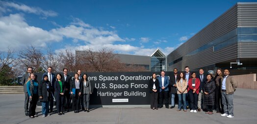  Twenty-two International Visitor Leadership Program participants posed for a photo at SpOC Headquarters, Peterson Space Force Base, Colo., April 14, 2023. The IVLP participants were briefed on SpOC’s mission and familiarized with Space Force structure and culture in an ongoing SpOC effort to nurture partnerships in the space domain. (US Space Force photo by SSgt Jose A. Rodriguez Jr)