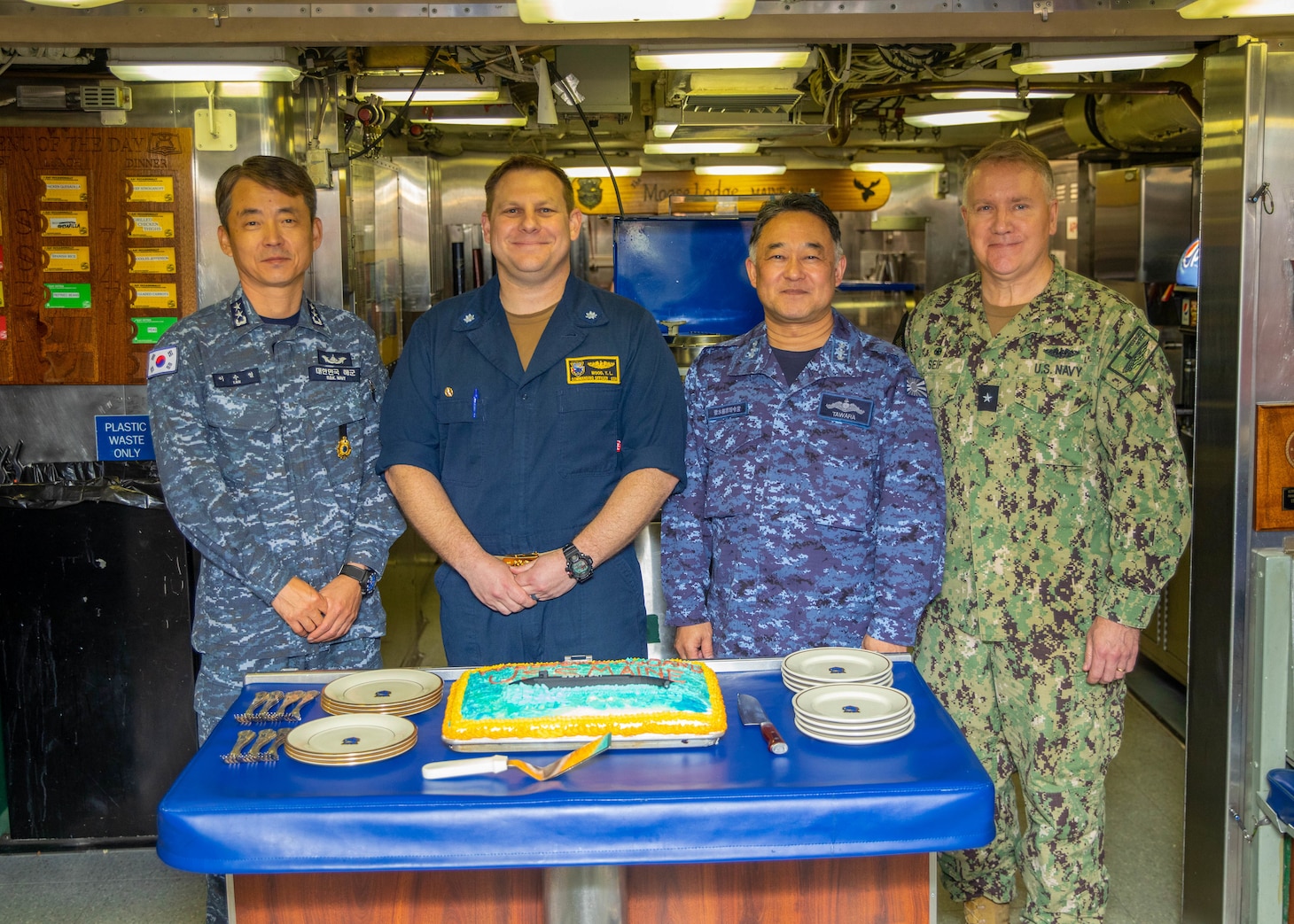 From left, Republic of Korea (ROK) Navy Rear Adm. Su Youl Lee, commander, ROK Navy Submarine Force; U.S. Navy Cmdr. Travis Wood, commanding officer of the Ohio-class ballistic-missile submarine USS Maine (SSBN 741) Gold crew; Japan Maritime Self-Defense Force (JMSDF) Vice Adm. Tateki Tawara, commander, Fleet Submarine Force;, and U.S. Navy Rear Adm. Rick Seif, commander, Submarine Group 7; pose for a photo during an underway embark aboard Maine, April 18.