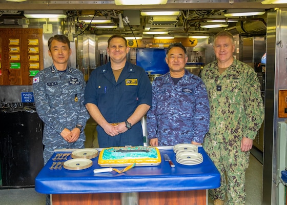 From left, Republic of Korea (ROK) Navy Rear Adm. Su Youl Lee, commander, ROK Navy Submarine Force; U.S. Navy Cmdr. Travis Wood, commanding officer of the Ohio-class ballistic-missile submarine USS Maine (SSBN 741) Gold crew; Japan Maritime Self-Defense Force (JMSDF) Vice Adm. Tateki Tawara, commander, Fleet Submarine Force;, and U.S. Navy Rear Adm. Rick Seif, commander, Submarine Group 7; pose for a photo during an underway embark aboard Maine, April 18.