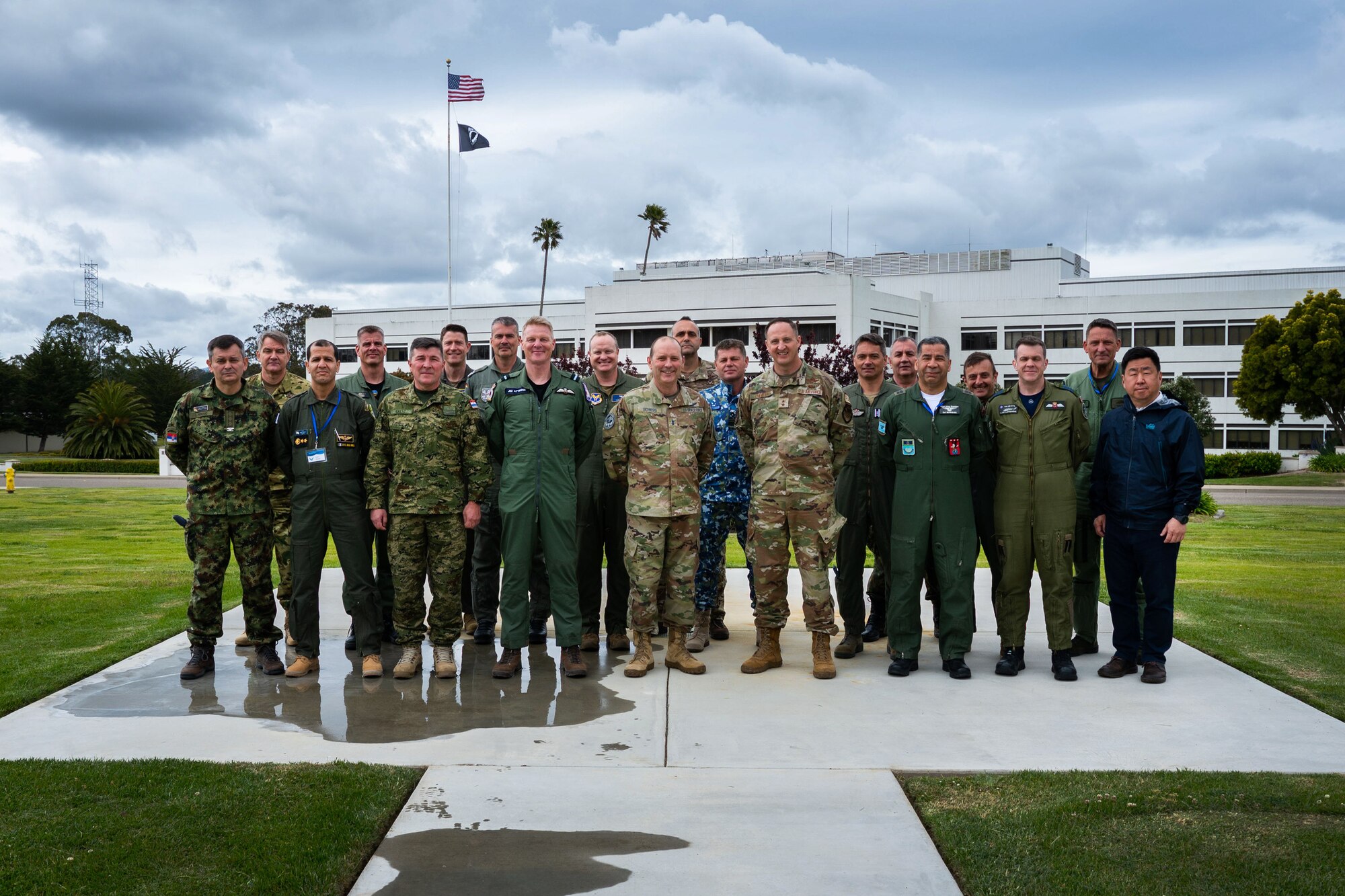 U.S. Space Force Maj. Gen. Douglas A. Schiess, Combined Force Space Component Command (CFSCC) commander, center, and U.S. Air Force Maj. Gen. Julian C. Cheater, Assistant Deputy Under Secretary of the Air Force International Affairs (SAF/IA), center right, stand for a group photo with participants of a SAF/IA-sponsored tour at Vandenberg Space Force Base, Calif., May 3, 2023. This DoD-level program aims to orient Attachés to DoD organizations and provide strategic messaging to senior foreign leaders, and is executed on behalf of the USAF Chief of Staff Gen. Charles Q. Brown. (U.S. Space Force photo by Tech. Sgt. Luke Kitterman)