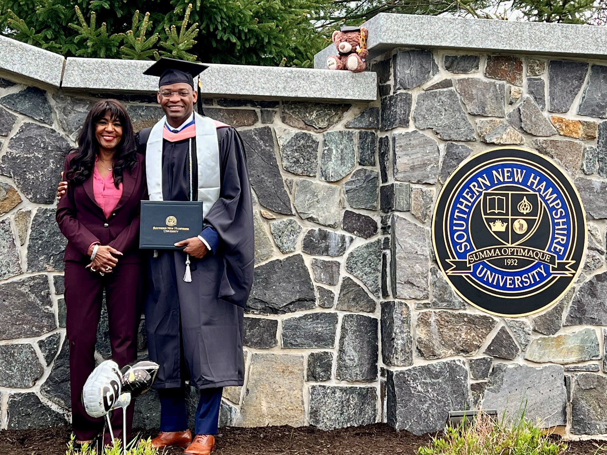 Senior Airman Dennis Spain, 75th Medical Group, with his mother at his graduation from Southern New Hampshire University.  Spain earned a master's degree in public health with an emphasis in epidemiology. (Courtesy photo)