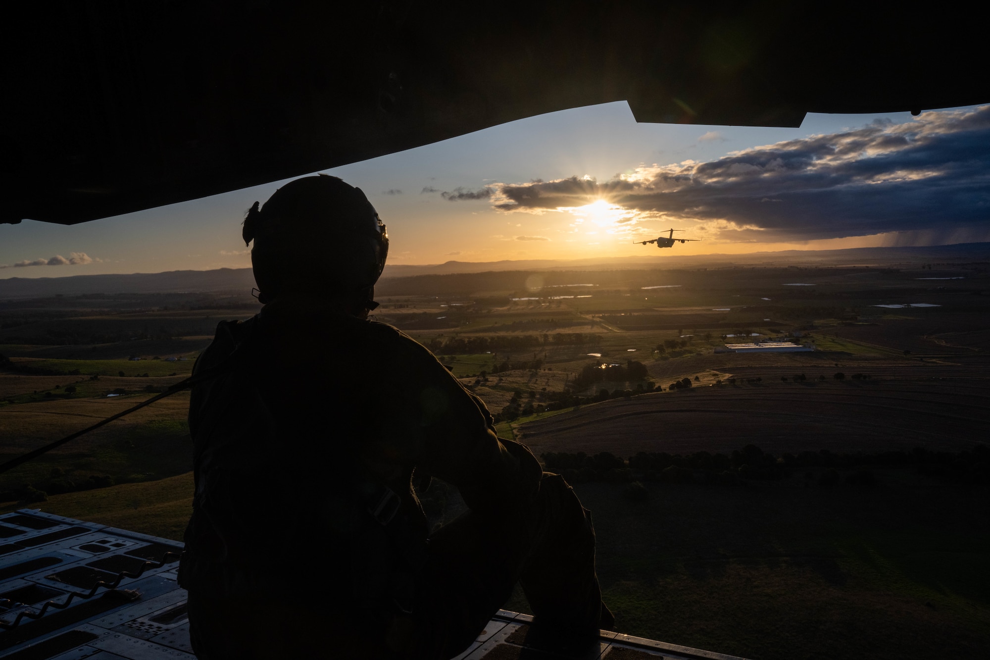 U.S. Air Force Tech Sgt. Joseph Hoffman, 535th Airlift Squadron advanced instructor course loadmaster, sits on the ramp of a C-17 Globemaster III during a training flight around the skies of Australia for Global Dexterity 23-1, April 27, 2023. This is the sixth iteration of Exercise Global Dexterity between the U.S. Air Force and our Indo-Pacific partners, the Royal Australian Air Force, and focuses on strengthening our military partnership in the region. The partnership between Australia and the U.S. is vital given the changing strategic environment in the region and demonstrates our commitment to revitalizing our alliances with our two closest allies. (U.S. Air Force photo by Senior Airman Makensie Cooper)