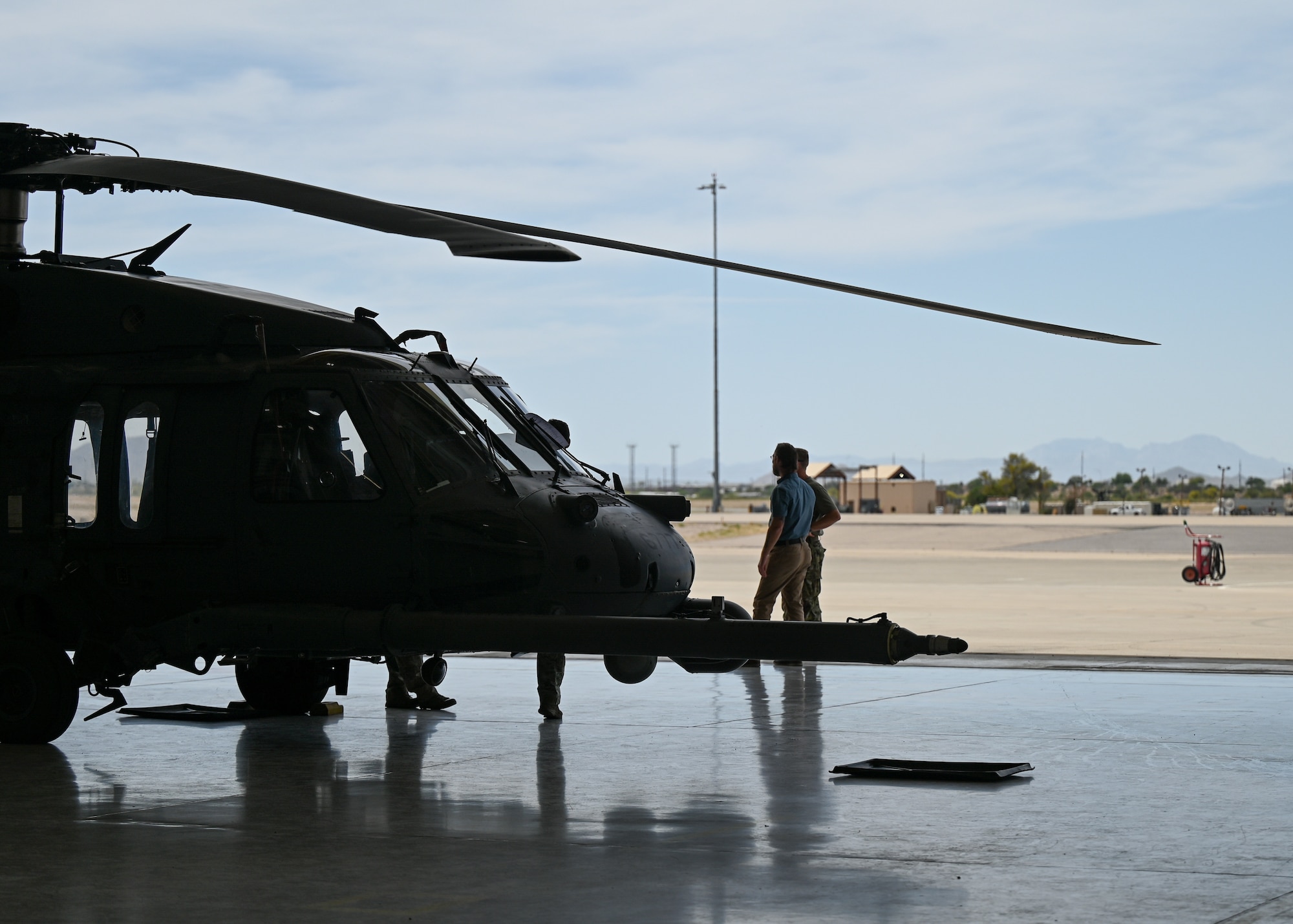 A helicopter is parked in a hangar.