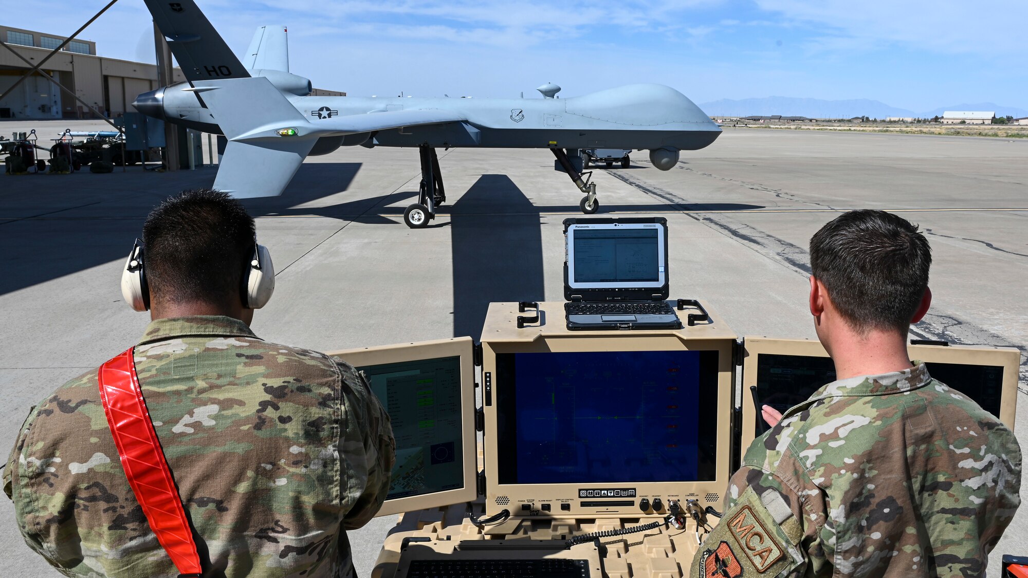 U.S. Air Force Staff Sgt. Erandy Rodriguez, 29th Aircraft Maintenance Unit MQ-9 Reaper avionics technician, left, and U.S. Air Force Senior Airman Alejandro Thompson, 29th AMU MQ-9 dedicated crew chief, use a portable aircraft control station at Holloman Air Force Base, New Mexico, May 3, 2023.