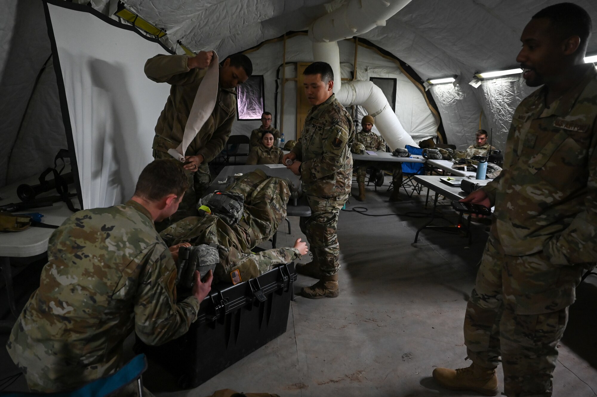 Airmen from 729th Air Control Squadron learn care-under-fire procedures during a Deployment Initial Readiness Training course
