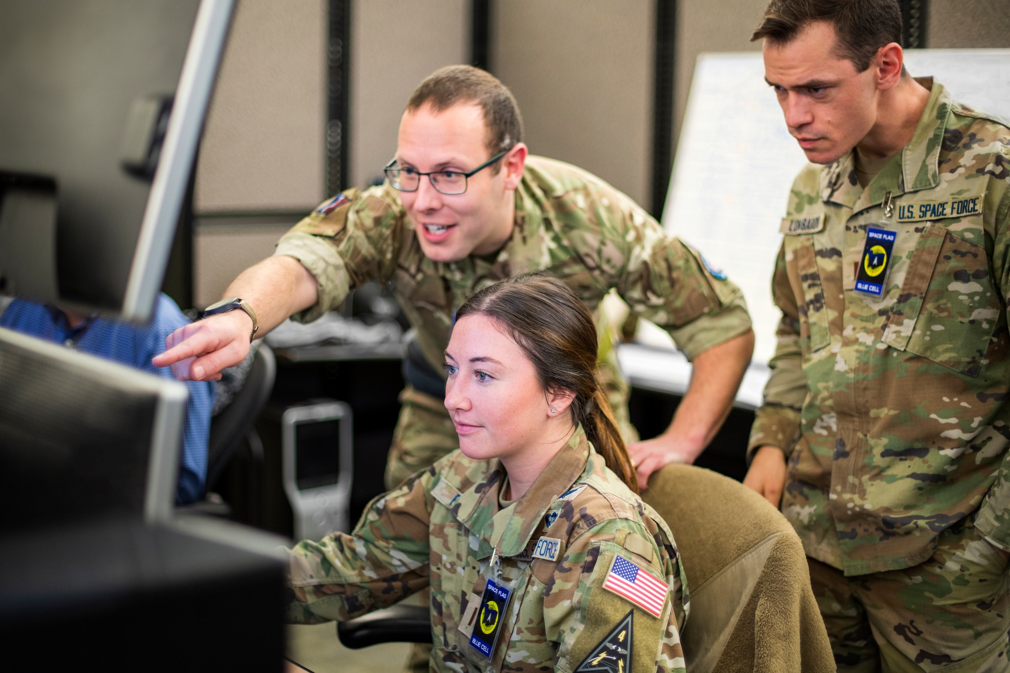 U.S. Space Force Guardians and a service member from the Royal Air Force work together during SPACE FLAG 23-2 at Schriever Space Force Base, Colorado, April 27, 2023. SPACE FLAG 23-2 was the largest exercise iteration to date, involving 250 participants. It was also the most complex integration of cyber warfare, the largest integration of coalition partners ever at a SPACE FLAG exercise, and the first SPACE FLAG exercise to feature live-fire space electronic warfare. (U.S. Space Force photo by Judi Tomich)