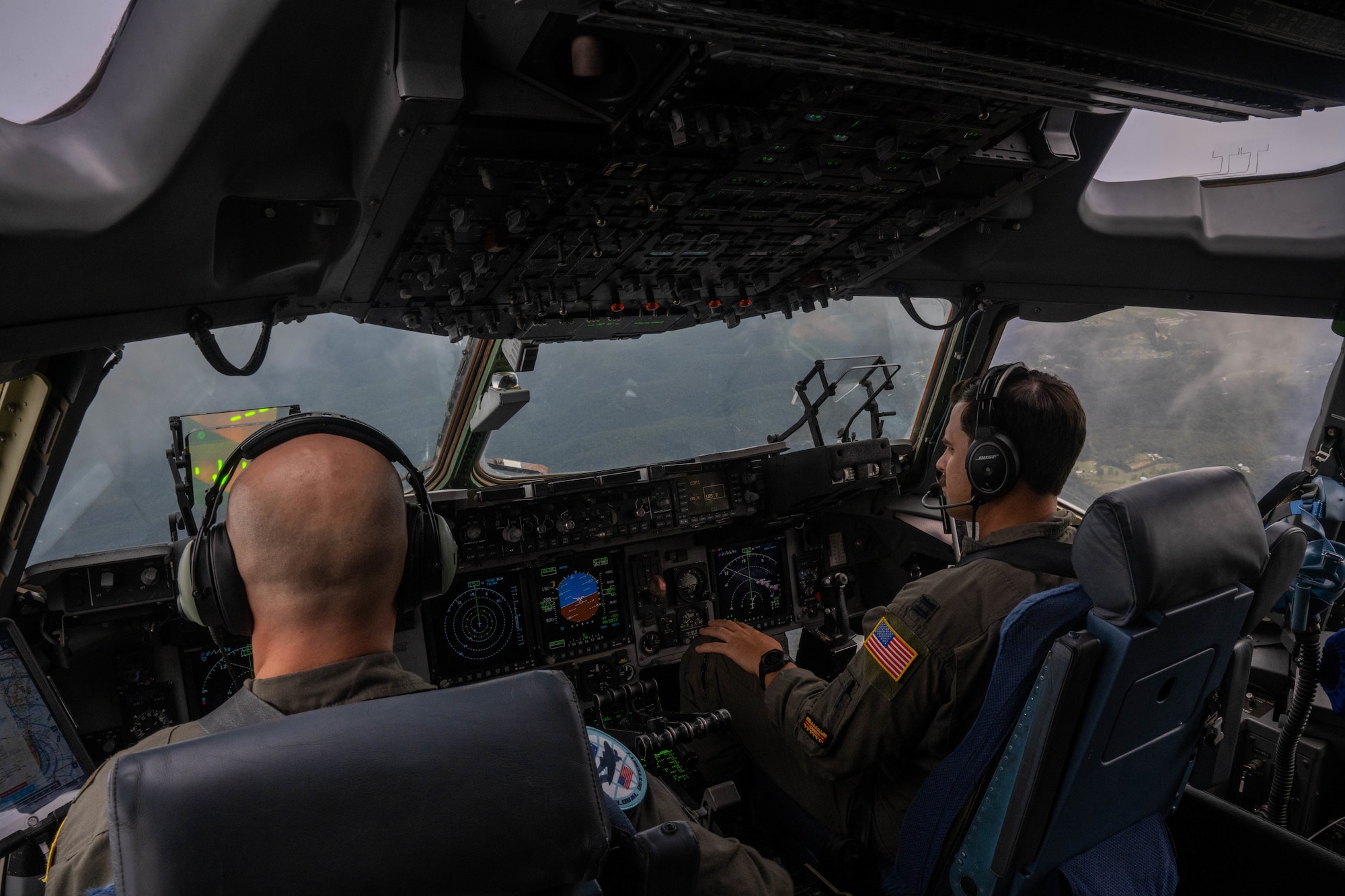 U.S. Air Force Maj. Dane Wold, No. 36 Squadron, pilot and U.S. Air Force Capt. Logan Hawke, 535th Airlift Squadron pilot, flies a C-17 Globemaster III during a training flight during Global Dexterity 23-1 around Queensland, Australia, April 25, 2023. Exercise Global Dexterity 2023 is being conducted at Royal Australian Air Force Base Amberley, and is designed to help enhance air cooperation between the U.S. and Australia and increase our combined capabilities, improving security and stability in the Indo-Pacific Region. (U.S. Air Force photo by Senior Airman Makensie Cooper)